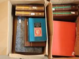 two boxes with books in them sitting on a table