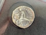a silver coin with a picture of a man on it