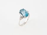 a blue topaze and diamond ring on a white background