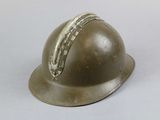 an old helmet is sitting on a table with a white background