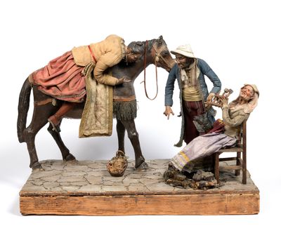 a figurine of a man sitting on a bench next to a horse