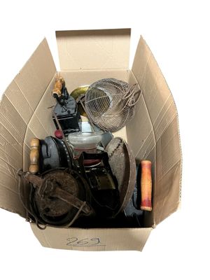 a cardboard box with a fan, a fan and other items in it