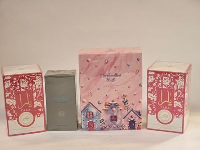 three boxes of perfume sitting next to each other on a white surface