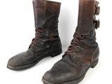 pair of brown leather boots with laces on them against a white background