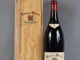 the bottle of wine is next to a wooden box