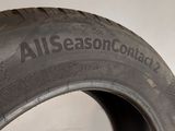 an all season tire on display in a showroom at a car show