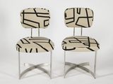 a pair of chairs with black and white lines on them