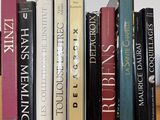 many books that are on a shelf in the room