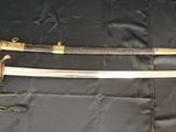 un gros plan d'une épée posée sur un tissu, sur une table