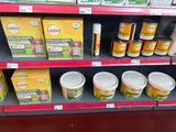 many containers of food on the shelves in the store
