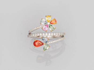 a close up of a ring with multi colored stones on it