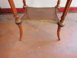 a small wooden table with a marble top on it