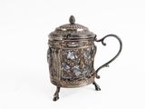 an antique silver teapot with a glass lid on a stand