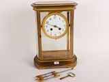 a small clock that is sitting next to a pair of scissors