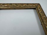 a close up of a gold frame with a white background