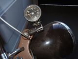 a close up of a motorcycle with a gauge on the handlebars