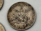 three coins sitting on top of a table next to each other