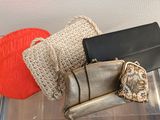 two bags and a purse sitting on top of a table