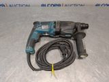 a close up of a corded drill with a cord attached to it