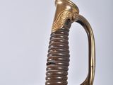 an image of a sword with a gold handle on a white background