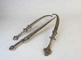 pair of antique silver plated swords on a white background