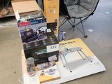a pile of boxes sitting on the floor next to a chair