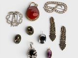 several different types of broochets and jewelry on a white surface