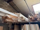 many stacks of wood sitting on a shelf in a room