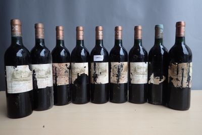 six bottles of wine are lined up in a row on a table