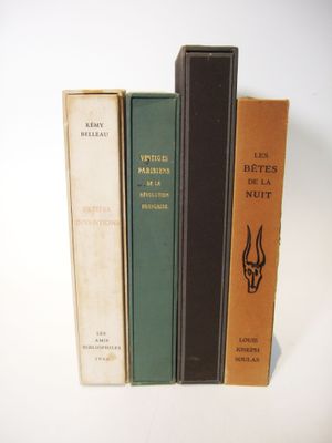 several books are lined up on top of each other on a white surface