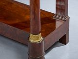 a wooden table with a brass plate on top of it