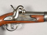 a close up of a gun on a table with a white background