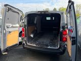 the back of a van with its doors open in a parking lot