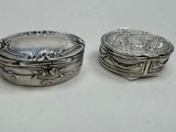 pair of antique silver plated boxes on a white surface