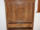 a wooden cabinet with a marble top in a room