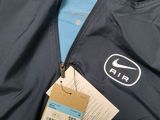 the back of a jacket with a tag on it and a tag attached to it