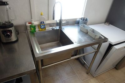 a kitchen with a stainless steel sink and a blender