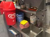 a red trash can and a red trash can in a kitchen