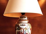 a lamp that is sitting on a table with a lamp shade on it