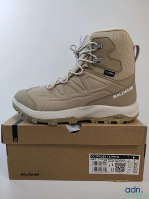 the shoe is on top of a box on a white surface