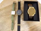two watches sitting on a table next to each other