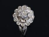 a close up of a diamond ring on a black surface