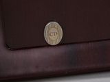 a coin sitting on top of a briefcase on a table