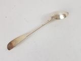 a spoon that is sitting on a white surface