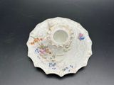 a small cup and saucer sitting on a table