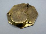 a brass plate with a compass on it