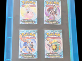 four pokemon cards in a blue case on a black background