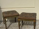 two stools that are sitting on a tiled floor