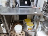 an image of a commercial kitchen with a lot of pots and pans on the counter