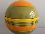 brightly colored bowls stacked on top of each other on a table